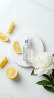 Clear glass dropper bottle with serum or essential oil on white marble plate, surrounded by fresh lemon slices and white peony flower for skincare, cosmetics, or wellness product marketing.