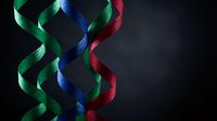 Colorful DNA double helix structure with green blue red strands on dark background for genetics research biotechnology medical science education.