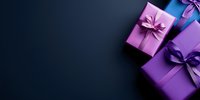 Purple and violet gift boxes with satin bows arranged on dark background with copy space, creating elegant festive composition for luxury presents.