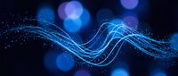 Abstract blue wave of glowing particles and light trails flowing across dark background, representing data flow, technology, energy, and digital communication for tech and science designs.