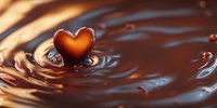 Heart-shaped drop splashing into liquid chocolate creating concentric ripples and waves against dark brown background with romantic mood lighting.