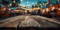 Rustic wooden table with blurred festive night market or street fair with string lights in background.