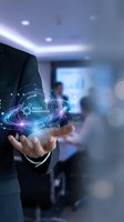 Businessman in dark suit holding glowing digital hologram displaying policy innovation concept with interconnected network lines and icons in modern office environment.