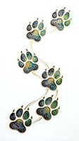 Ornamental paw prints in blue, green, and gold with decorative swirls and flourishes isolated on white background, ready for clipart and design use.