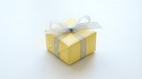 Yellow gift box with silver ribbon bow isolated on white background for holiday celebrations and special occasions.