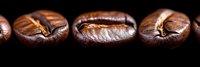 Macro shot of roasted coffee beans in row on black background showing detailed texture and rich brown color, perfect for cafe and restaurant marketing materials.