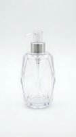 Clear glass pump dispenser bottle with silver cap isolated on white background for cosmetic and skincare product packaging design.