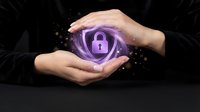 Hands protecting glowing purple cybersecurity shield with padlock icon representing data protection and digital security solutions for business.