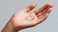 Moisturizing cream heart shape on female palm against light background showing skincare, beauty, and cosmetic product presentation concept.