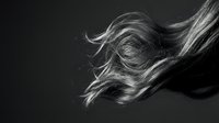 Flowing blonde hair in motion against dark background showcasing natural movement and texture for beauty and haircare concepts.