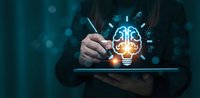 Businessperson holding tablet with glowing AI brain and light bulb hologram, symbolizing innovation, technology, and creative thinking.