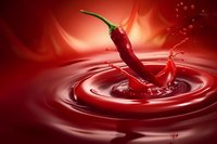 Red chili pepper splashing into liquid creating ripples, dynamic food photography for culinary, cooking, and spice-related design projects.