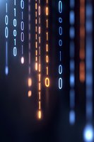 Glowing binary code streams in blue and orange neon colors falling on dark background, creating futuristic digital matrix effect for technology concepts.