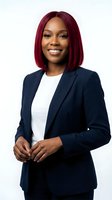 Professional African American businesswoman with burgundy bob haircut smiling confidently in navy blazer and white top on isolated white background.
