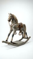 Vintage wooden rocking horse with dapple gray paint, leather saddle, rope reins, and real hair mane, isolated on white background.