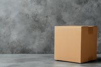 Closed cardboard box on concrete floor against textured gray wall background. Minimalist composition for delivery, storage and moving concepts.