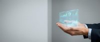 Businessman hand holding holographic display with financial charts and growth analytics data visualization for business strategy.
