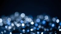 Abstract blue bokeh lights on dark background creating dreamy atmosphere for presentations, web design, and digital projects.