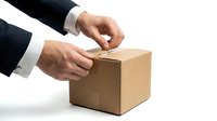 Male hands in business attire sealing a cardboard box with tape. Suitable for logistics, shipping, packaging, delivery services, e-commerce, and business operations content.