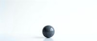 Dark blue marble sphere on white surface with clean minimalist background for product photography and design projects.