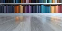 Colorful book spines arranged in rainbow spectrum order on wooden shelf with dramatic perspective view and blurred foreground creating depth and focus effect.