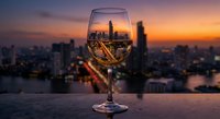 Wine glass with city skyline reflection at sunset creating artistic urban photography concept for luxury lifestyle and evening entertainment.