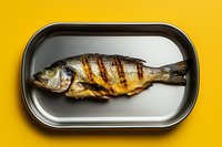Grilled whole fish with golden crispy skin served on metal tray against bright yellow background for culinary and restaurant menu designs.