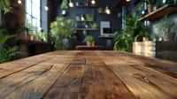 Empty wooden table in cozy restaurant interior with green plants, pendant lights and blurred background. Focus on rustic wood surface texture for product display.
