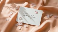 Thank you card on soft peach silk fabric with delicate pink flower petals, elegant calligraphy script, romantic and gentle aesthetic.