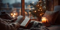 Cozy winter evening with open book, glowing candle, and Christmas tree lights creating warm atmosphere by window overlooking snowy landscape.
