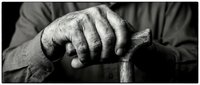 Elderly person's weathered hand gripping wooden cane handle in monochrome, depicting aging, mobility support, and life experience for healthcare and senior care concepts.