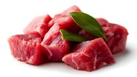 Fresh raw beef chunks with bay leaves on white background isolated for culinary design and cooking recipes.