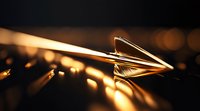 Paper airplane glowing in warm golden light against dark background with bokeh effect creates atmospheric minimalist composition for business concepts.