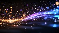 Magical glowing particles and light trails creating dynamic motion effect against dark background with golden and blue sparkles for festive designs.