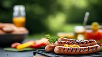 Grilled sausages with grill marks on barbecue grate outdoors, fresh vegetables and cold beer in background, summer cookout setting with bokeh effect.