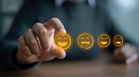 Businessman selecting customer feedback rating with glowing yellow emoji faces on dark background showing satisfaction level and service review.