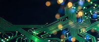 Close-up of glowing green circuit board with interconnected pathways and bokeh lights, representing technology, data processing, and digital innovation for tech backgrounds.