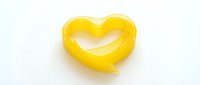 Yellow heart-shaped pasta on white background isolated for cooking and food design projects.