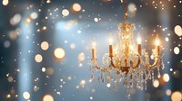Elegant crystal chandelier with lit candles against blue background with dreamy bokeh lights creating festive atmosphere.