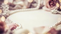 Elegant wedding jewelry with pearls and roses creating romantic bridal accessories frame on soft blurred background for luxury celebration design.