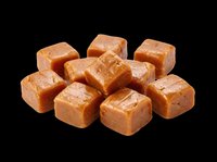 Soft caramel candy cubes pile isolated on transparent background, ready for t-shirt design, stickers, clipart, print on demand, and sublimation projects.