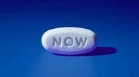 White oval pill with "NOW" imprint on blue background, casting shadow. Pharmaceutical medication concept for healthcare and treatment options.