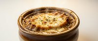 Savory meat pie with golden pastry crust and herb garnish, ready to serve. Suitable for food photography, culinary blogs, restaurant menus, and cooking publications.