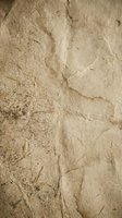 Natural beige limestone texture with cracks and weathered surface for backgrounds and design projects.
