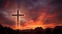 Wooden cross silhouette against dramatic sunset sky with orange and purple clouds over mountain landscape for spiritual and religious themes.