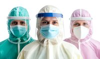 Medical workers wearing protective equipment, face masks, and face shields in green, white and pink PPE suits standing in row, frontline healthcare concept.