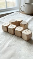 Wooden letter blocks spelling EMDR on linen fabric near window with coffee mug creating cozy therapeutic workspace atmosphere for mental health professionals.