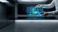 Hands manipulating holographic digital architecture interface in modern workspace, representing technology innovation and virtual design development.