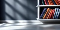 Books arranged on white shelf against dark wall with dramatic window light and shadows creating minimalist study atmosphere. Suitable for education concepts.