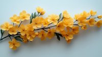 Yellow spring flowers on branch with green leaves against light blue background, floral arrangement for decorative design and greeting cards.